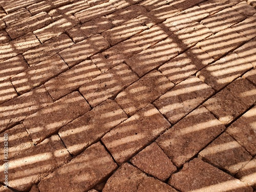 Laterite ground that leads together as a line of sight With the shadow falling onto the surface.