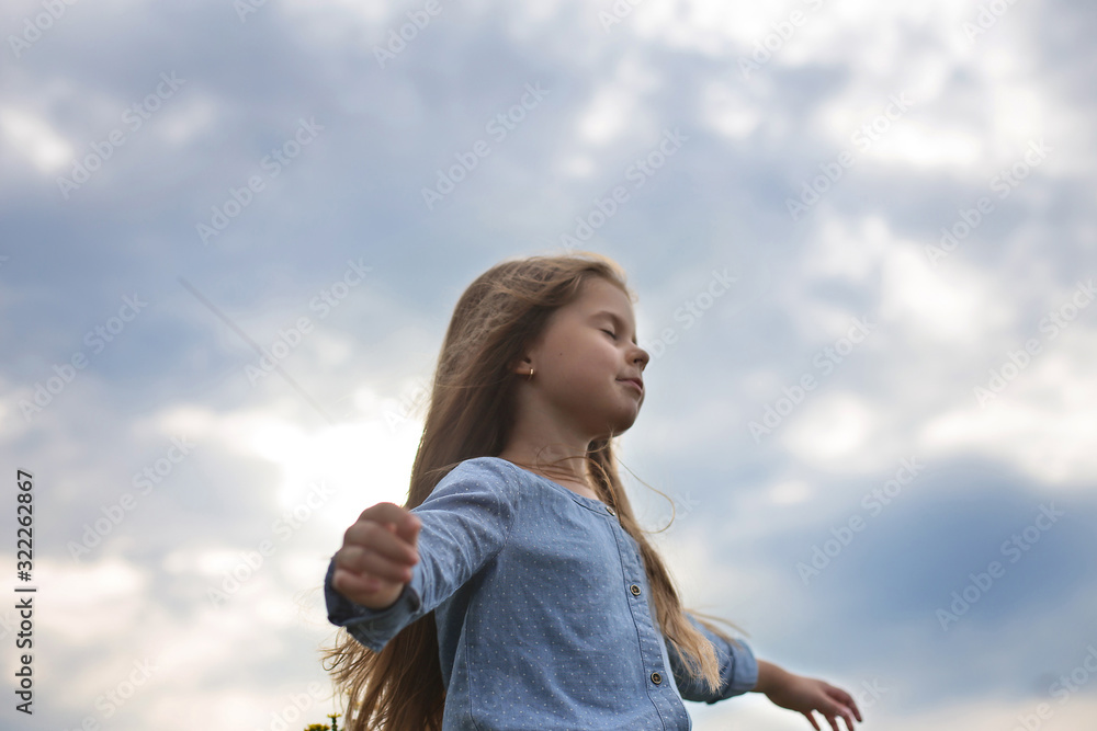 horizontal photo six year old girl with long hair stands with closed eyes horizontal photo six year old girl with long hair stands with closed eyes