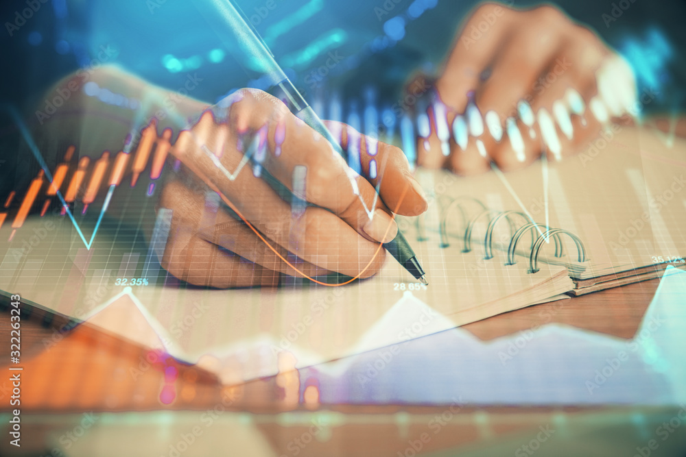 Forex graph on hand taking notes background. Concept of research. Double exposure Forex graph on hand taking notes background. Concept of research. Double exposure
