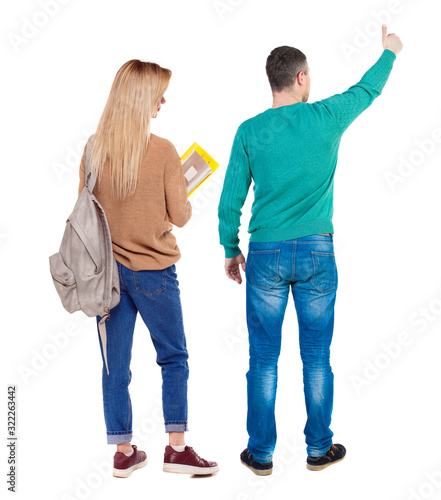 Back view of couple couple in sweater showing thumbs up.