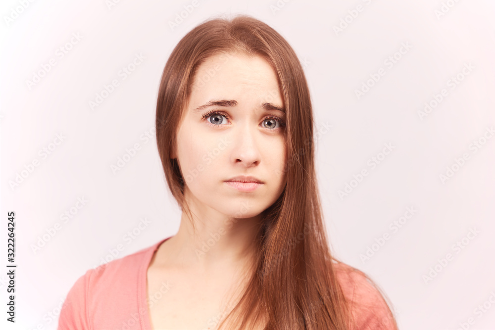Abused female with sorrowful expression, curves lower lips discontent look. Young beautiful girl with ginger hair Bob haircut green eyes wears black turtleneck isolated on white background in Studio Abused female with sorrowful expression, curves lower lips discontent look. Young beautiful girl with ginger hair Bob haircut green eyes wears black turtleneck isolated on white background in Studio