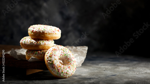 Canvastavla Fresh sweet donuts on dark background and copy space for your decoration