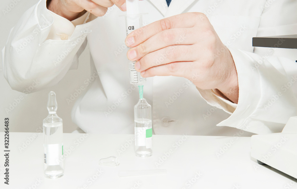 Doctor holds ampoules with medicine Doctor holds ampoules with medicine