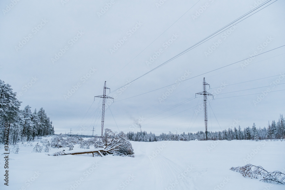 Transposition power transmission towers in snowy north forest