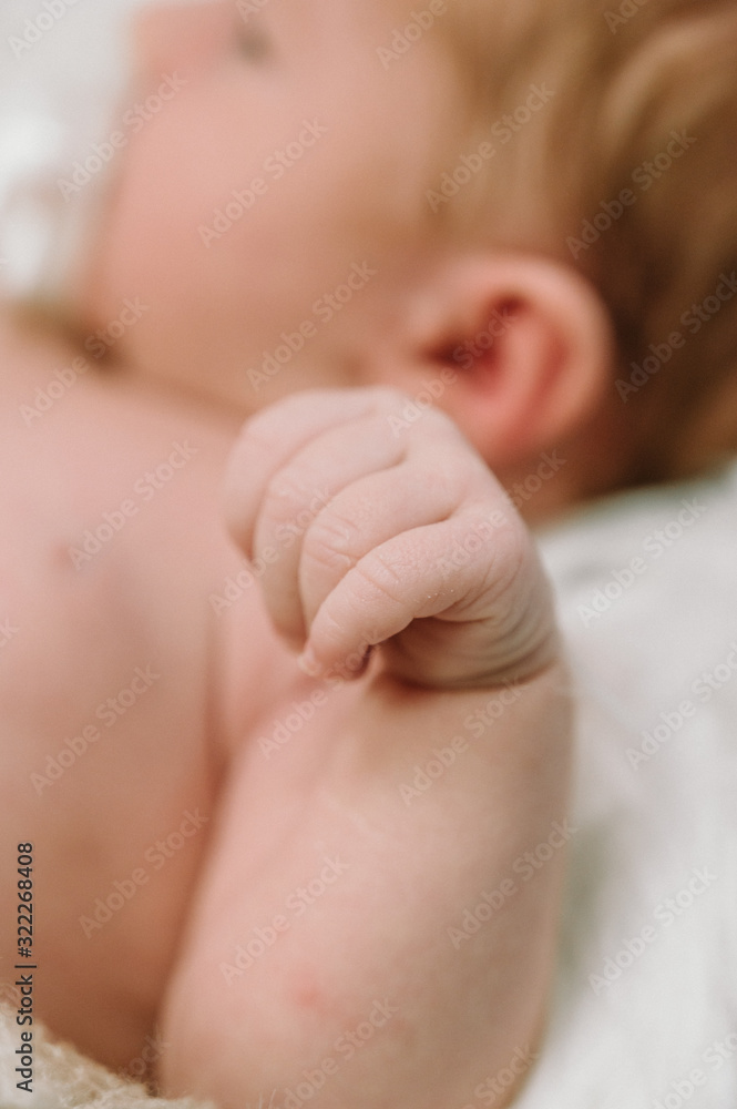 Fist of Newborn Baby - Happy family concept.