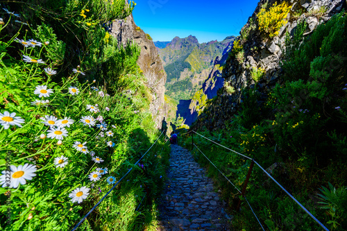 Beautiful hiking trail from Pico do Arieiro to Pico Ruivo, Madeira island. Footpath PR1 - Vereda do Areeiro. On summy summer day above the clouds. Portugal. photo