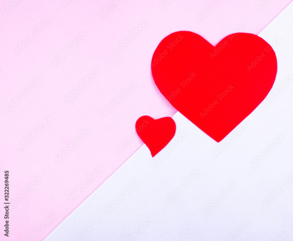 Two red hearts on a pink and blue background with space for text.