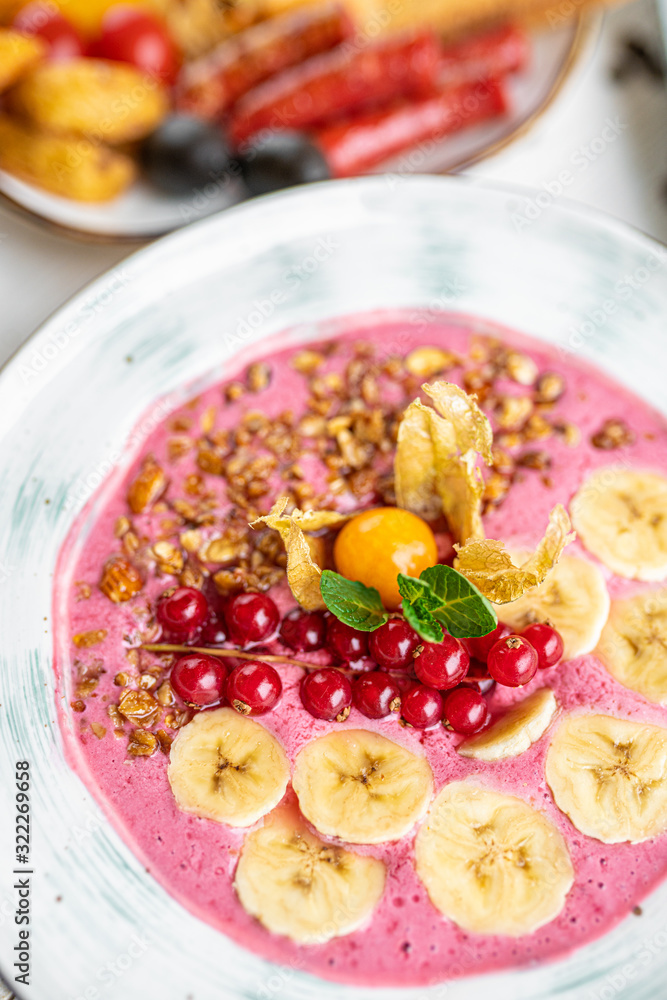 pink porridge with banana and berries on a white background. tasty porridge with fruits. healthy breakfast pink porridge with banana and berries on a white background. tasty porridge with fruits. healthy breakfast