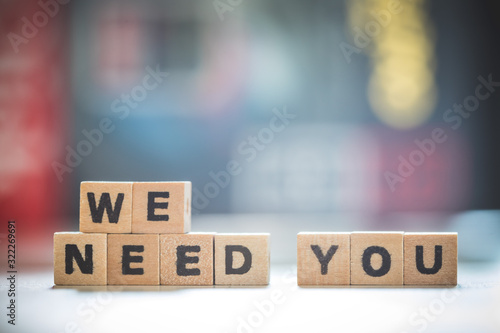 Hiring and recruiting concept: Wooden “we need you” letters.