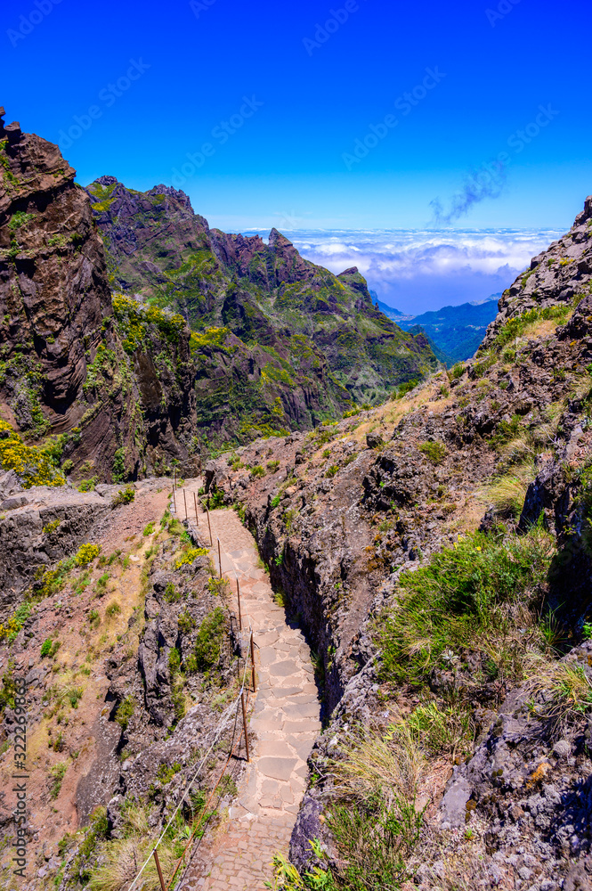 Beautiful hiking trail from Pico do Arieiro to Pico Ruivo, Madeira island. Footpath PR1 - Vereda do Areeiro. On summy summer day above the clouds. Portugal. Beautiful hiking trail from Pico do Arieiro to Pico Ruivo, Madeira island. Footpath PR1 - Vereda do Areeiro. On summy summer day above the clouds. Portugal.