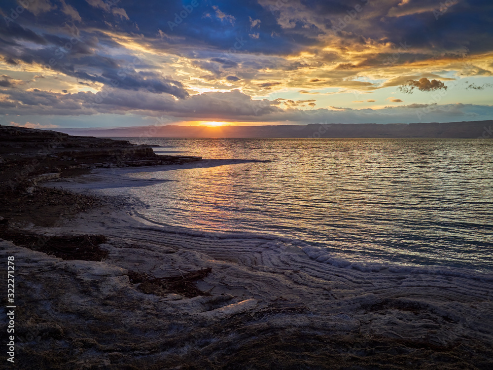 Beautiful sunset at Dead Sea, Jordan. Salt beach