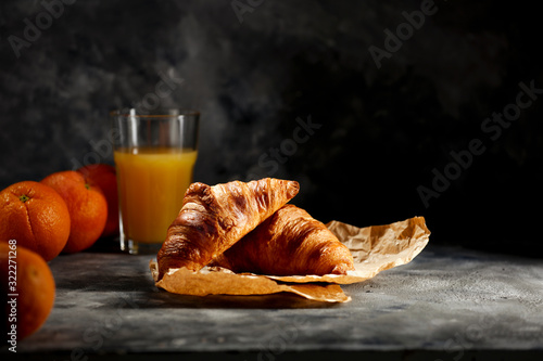 Dark mood background and fresh croissants on board.Free space for your decoration and breakfast time.  photo