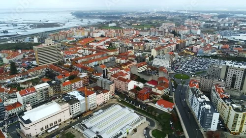 Aerial, pan, drone shot, overlooking downtown Aveiro city, on a overcast day, in Centro, Portugal