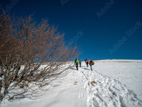 Group of hikers reaches the summit of Mutria Mount peak on mountain range of the Campania Apennines