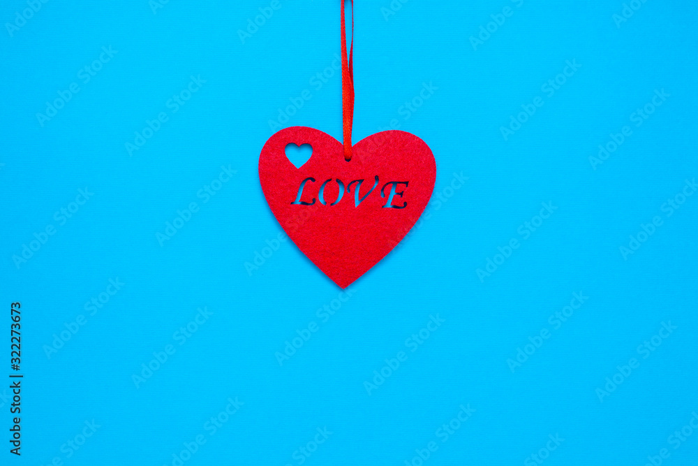 Decorative heart with the inscription love on a blue background Decorative heart with the inscription love on a blue background