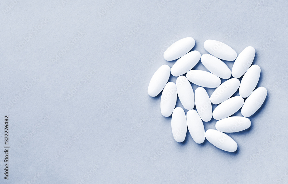 Circle shape made from pills for therapy, concept of treatment and health care on classic blue