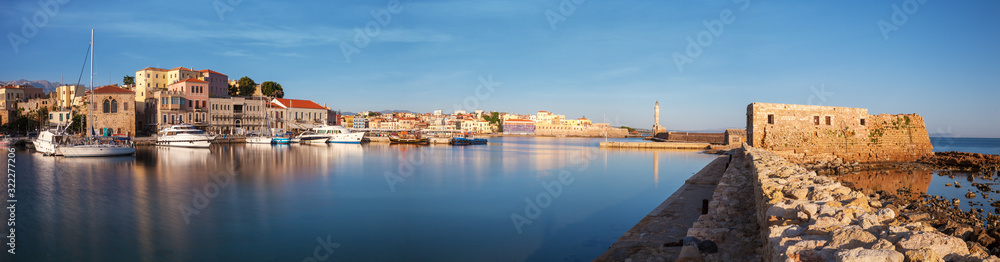 Panorama of Old harbor of Chania with the lighthouse and fortification at sunrise, Crete, Greece
