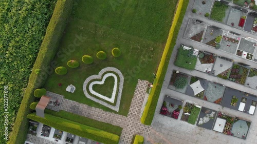 A zoom drone shot of a cemetery decoration. Whiteheart on the lawn. photo