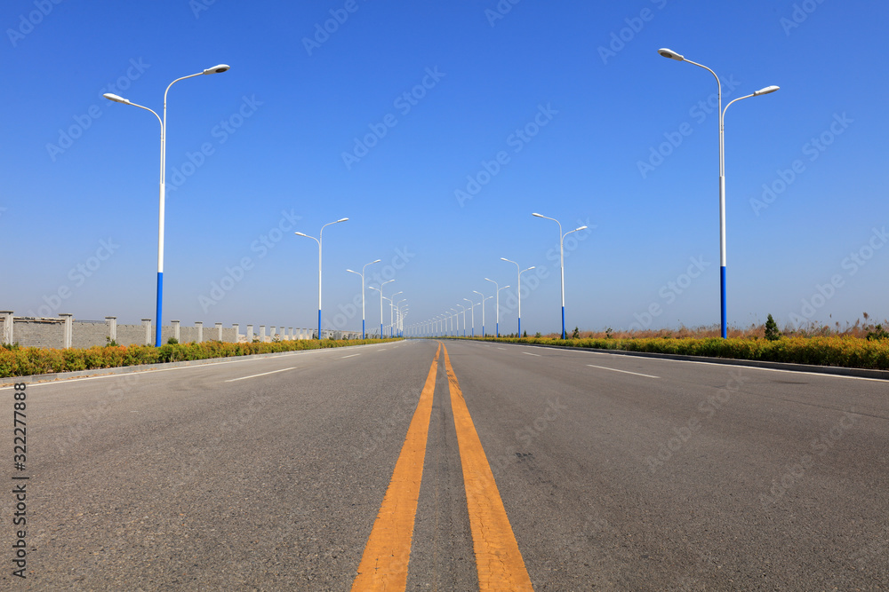 Urban roads and street lights under the blue sky