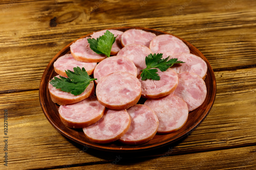 Ham sausage on a plate on wooden table