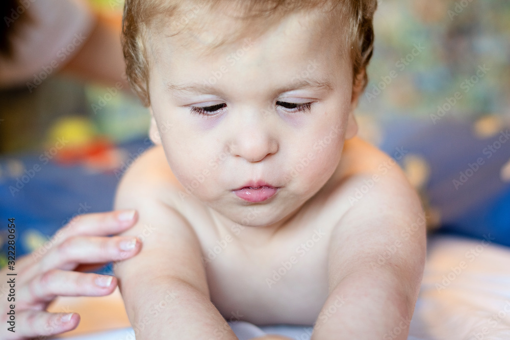 Baby having back massage in a children rehabilitation center. Little child relaxing on therapy. Massage therapist massaging a baby.. Baby having back massage in a children rehabilitation center. Little child relaxing on therapy. Massage therapist massaging a baby..