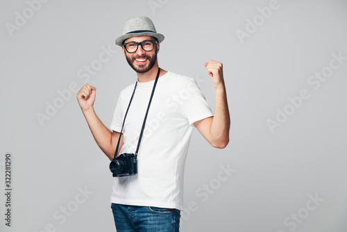 Successful young photographer smiling isolated
