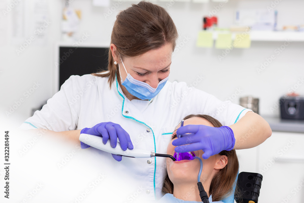 Young woman having teeth examined by female dentist in dental office. Young woman having teeth examined by female dentist in dental office.