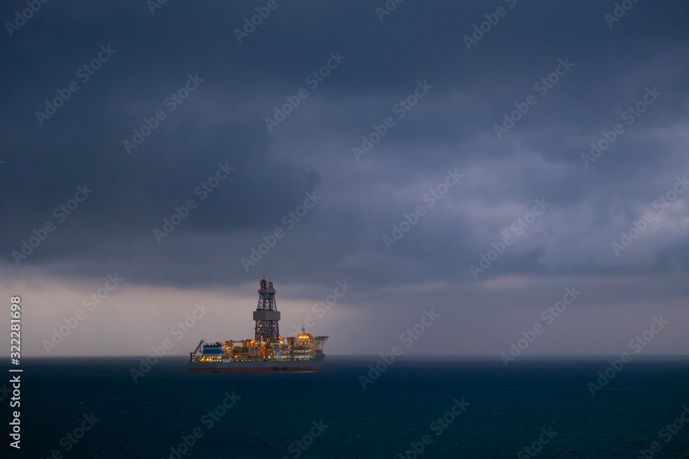 offshore oil drilling ship before the storm in the sea 