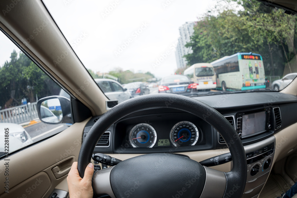 Driving car on city street in traffic jam Driving car on city street in traffic jam