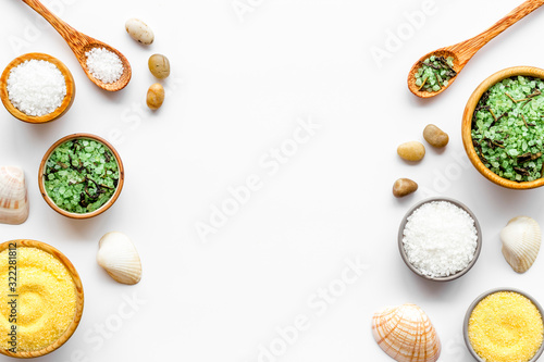 Spa cosmetics. Set of salt in bowls on white wooden background top-down frame copy space