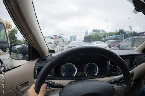 Driving car on city street in traffic jam