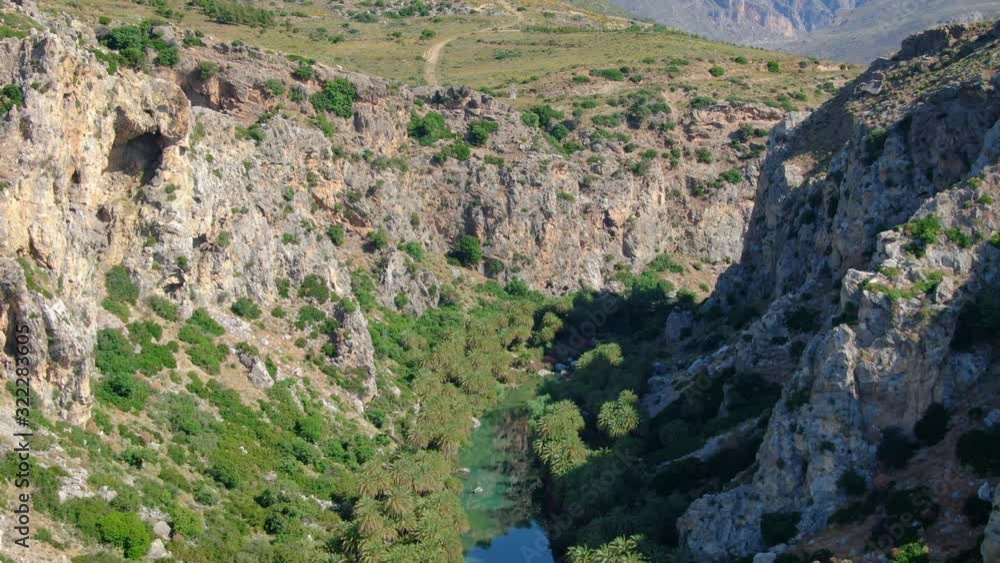 Aerial flying through a gorge over Kourtaliotis river in the island of Crete, Greece Aerial flying through a gorge over Kourtaliotis river in the island of Crete, Greece