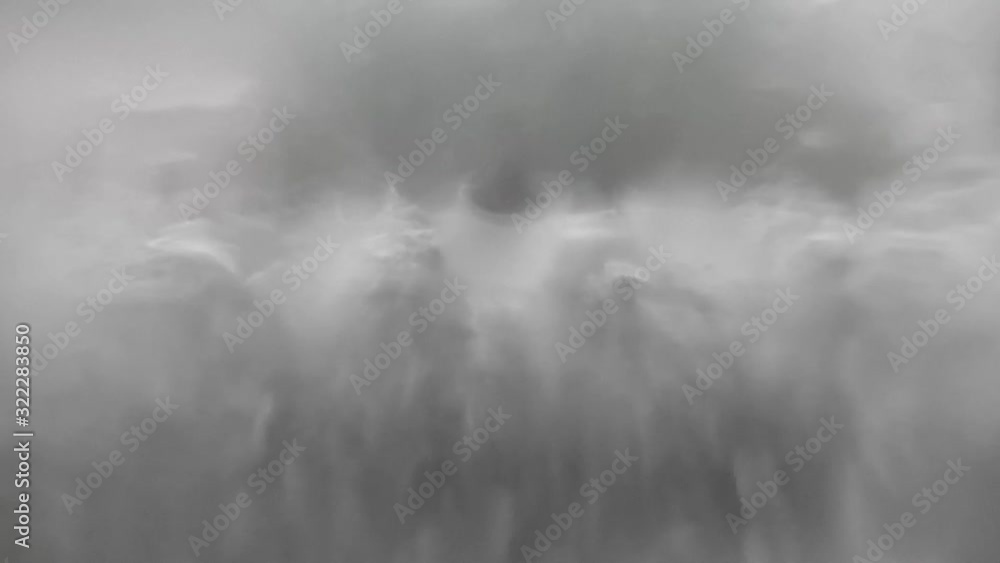 Rain drops on window glass close focus surreal blur effect as camera moves across Rain drops on window glass close focus surreal blur effect as camera moves across