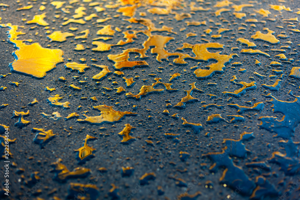 Water drops with ice colored with the sun in orange on asphalt textured abstract background Water drops with ice colored with the sun in orange on asphalt textured abstract background