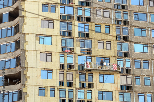 Photography Construction site residentaial apartment building prepared for installation insulation ventilated facade with suspenden craddle elevator