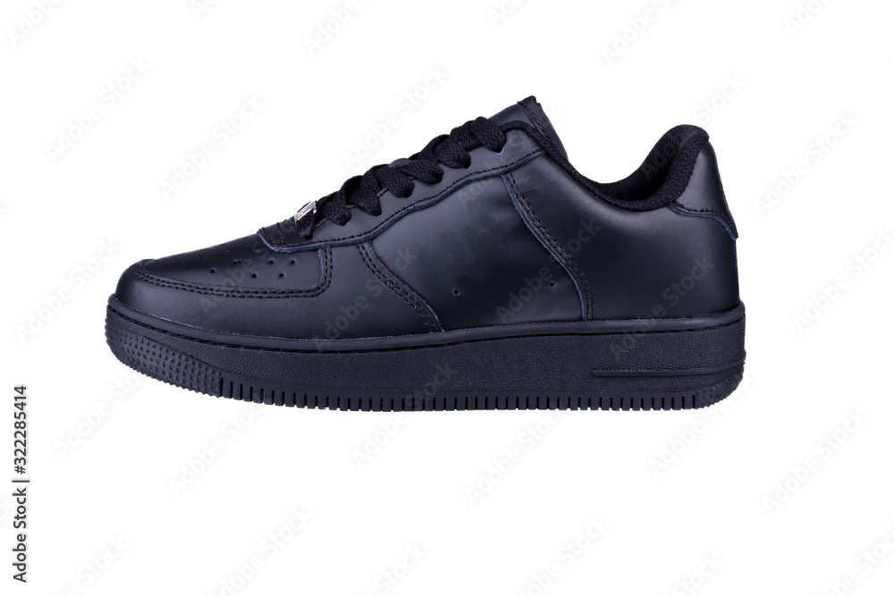 One black sneaker on a white background. Sport shoes. One black sneaker on a white background. Sport shoes.