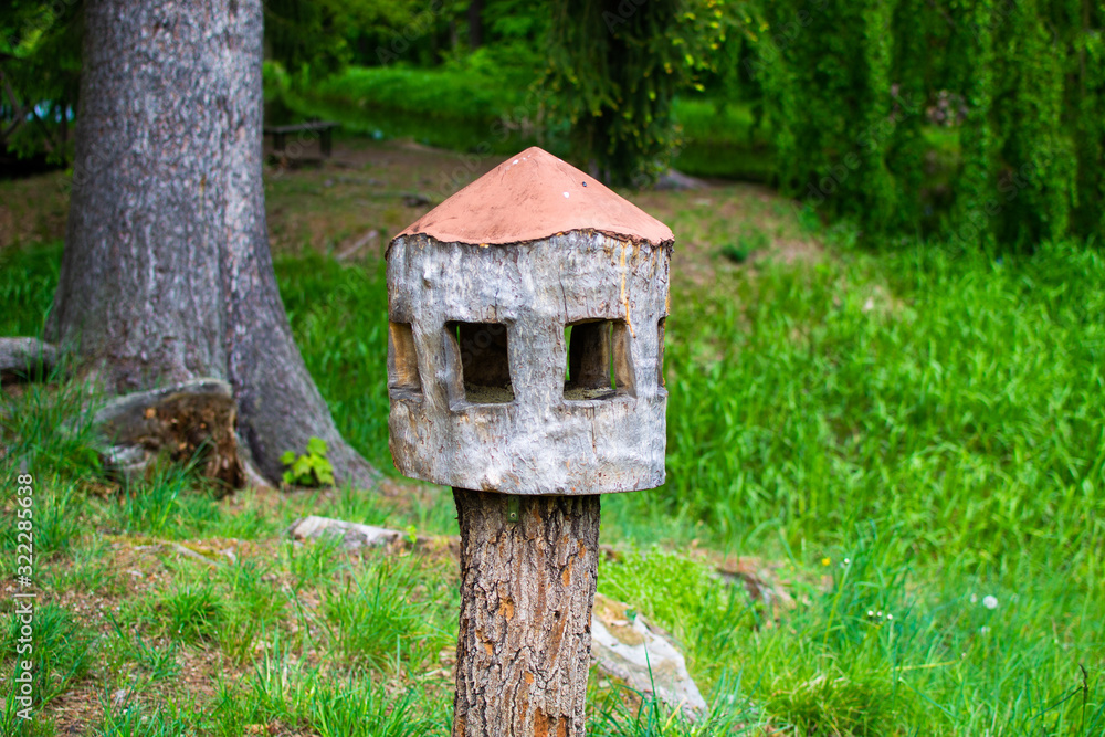 Wooden nest box for birds made with a tree trunk in Zamecky Park, in Hluboka Castle, Hluboka nad Vltavou, Czech Republic Wooden nest box for birds made with a tree trunk in Zamecky Park, in Hluboka Castle, Hluboka nad Vltavou, Czech Republic