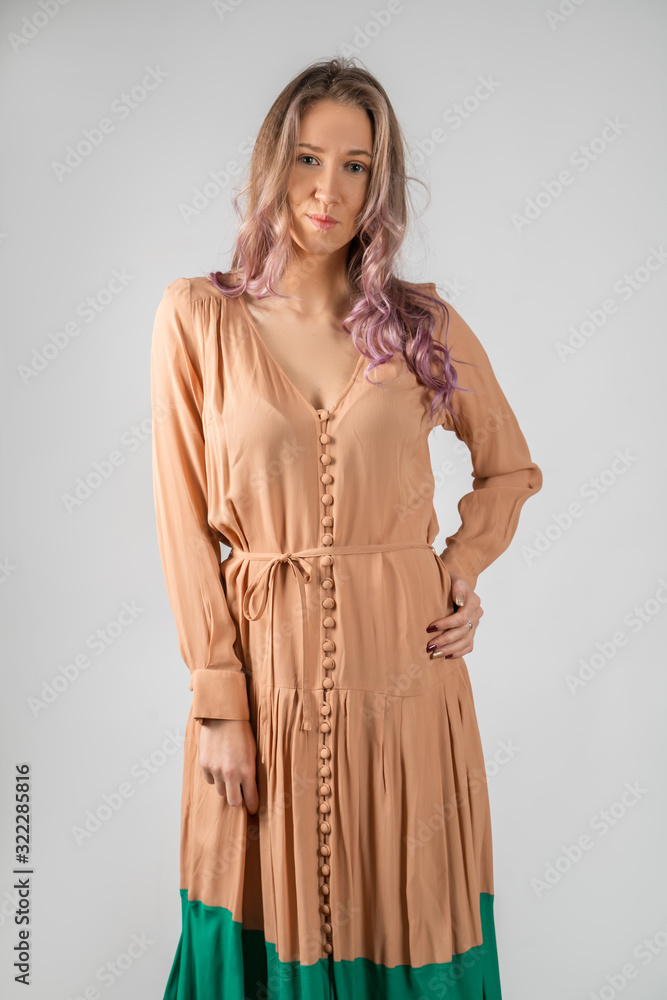 Girl in a coffee-colored dress with blue isolated on a white background. Girl in a coffee-colored dress with blue isolated on a white background.