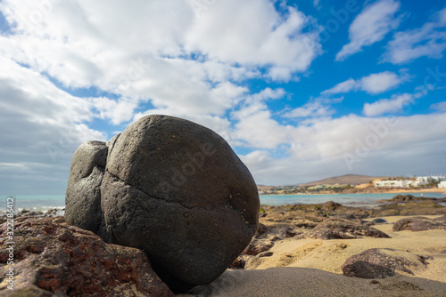 Big stone on a sandy beach near the sea