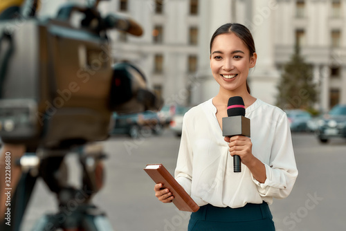 On air. TV reporter presenting the news outdoors. Journalism industry, live streaming concept.