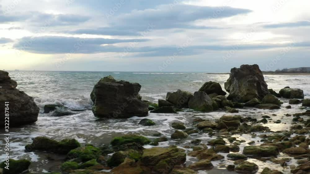 Wild sea beach, aerial view. Ukrainian landscape. Rocky beach at the sunset. Sea waves. Holidat on the sea Wild sea beach, aerial view. Ukrainian landscape. Rocky beach at the sunset. Sea waves. Holidat on the sea