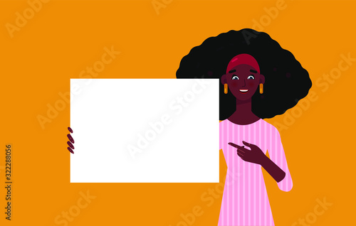 young african woman holding, showing, displaying white blank board, banner, poster. Young smiling woman on orange background showing empty poster.