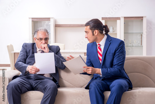 Two businessman discussing business in office