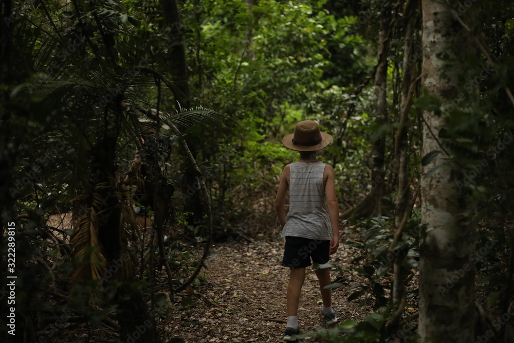 Little boy on a tropical adventure in a rainforest in the Whitsundays, Queensland Australia