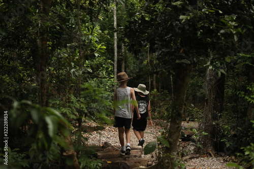 Boys walking through bush land in the Whitsundays, Queensland Australia