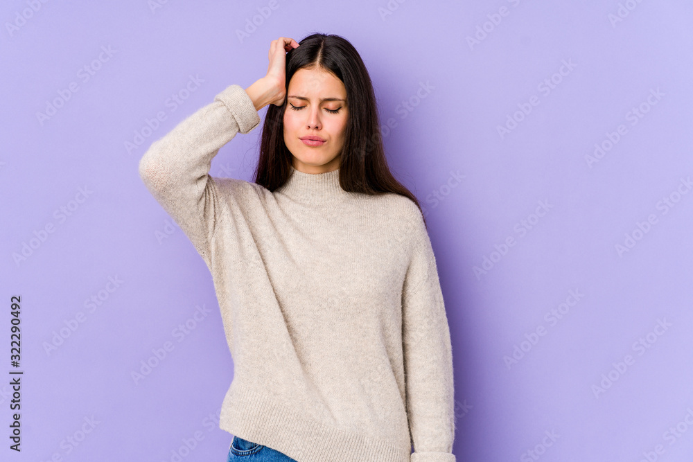 Young caucasian woman isolated on purple background tired and very sleepy keeping hand on head. Young caucasian woman isolated on purple background tired and very sleepy keeping hand on head.