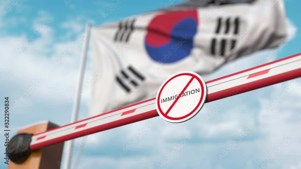 Closed boom gate with no immigration sign on the Korean flag background. Restricted border crossing or immigration ban in South Korea Closed boom gate with no immigration sign on the Korean flag background. Restricted border crossing or immigration ban in South Korea