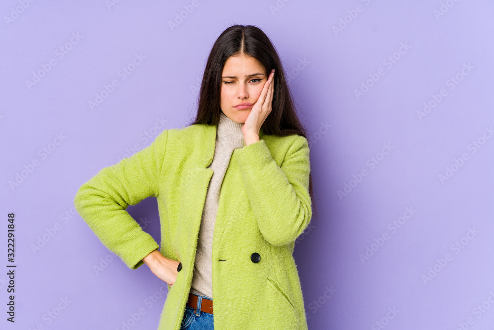 Young caucasian woman isolated on purple background who feels sad and pensive, looking at copy space. Young caucasian woman isolated on purple background who feels sad and pensive, looking at copy space.