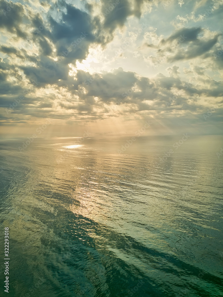Aerial view of a Sunrise sky background. Aerial Dramatic gold sunrise with morning sky clouds over the sea. Stunning sky clouds in the sunrise. Aerial photography.
