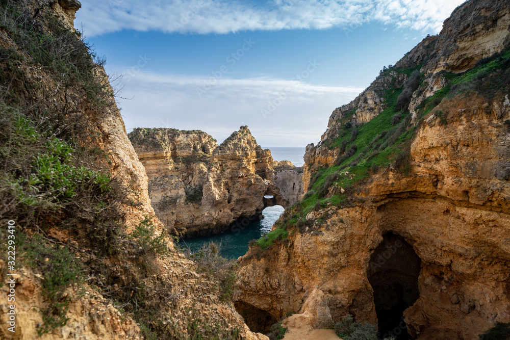 Scenic natural cliff formations and arches of Algarve coastline with turquoise water at Ponta da Piedade, in Algarve Portugal